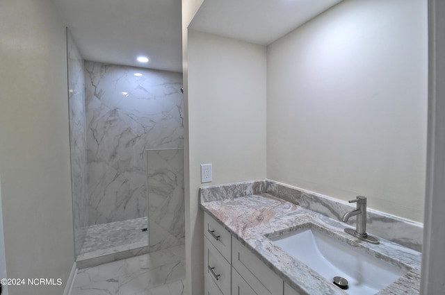 bathroom featuring vanity and tiled shower