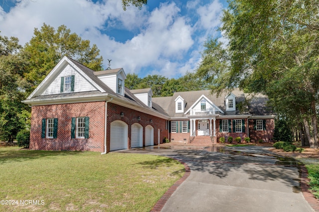 new england style home featuring a front yard and a garage