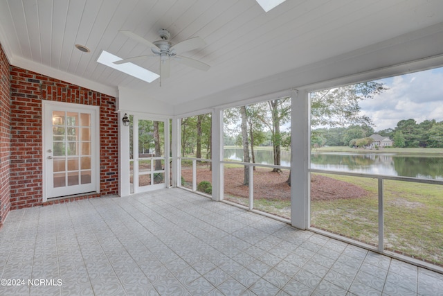 unfurnished sunroom with wooden ceiling, vaulted ceiling with skylight, a water view, and ceiling fan