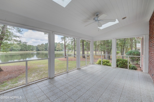 unfurnished sunroom featuring vaulted ceiling with skylight, a water view, ceiling fan, and wooden ceiling