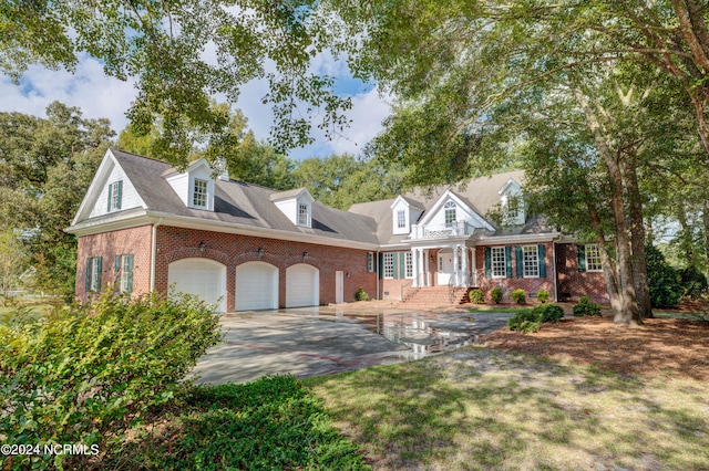 cape cod-style house with a garage and a front yard