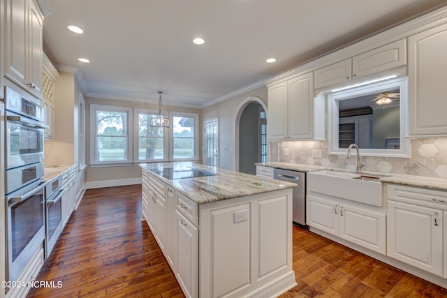 kitchen featuring pendant lighting, dark hardwood / wood-style floors, decorative backsplash, and a center island