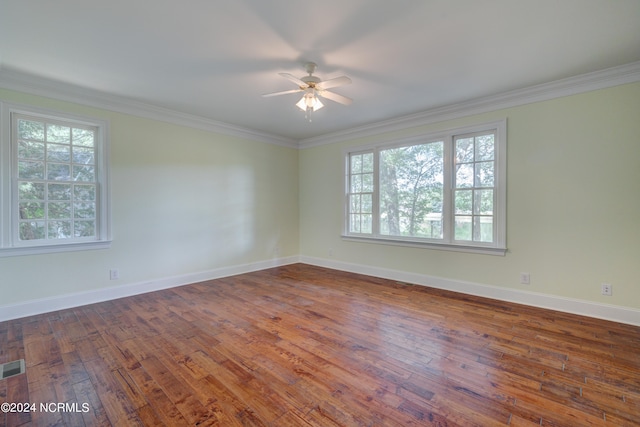 unfurnished room with a healthy amount of sunlight, dark hardwood / wood-style flooring, and ceiling fan