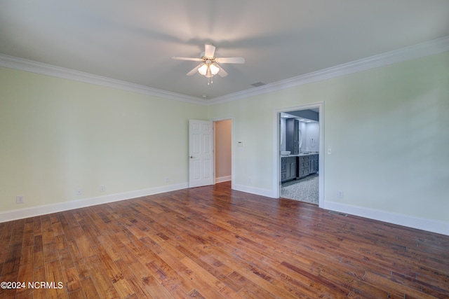 spare room with ceiling fan, hardwood / wood-style floors, and crown molding