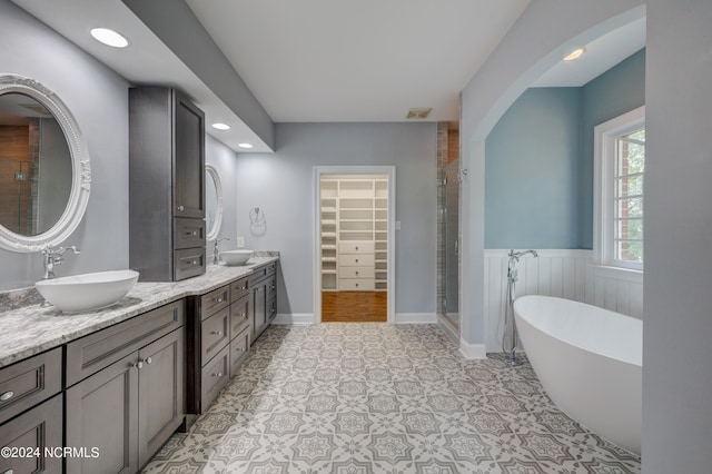 bathroom featuring vanity and plus walk in shower