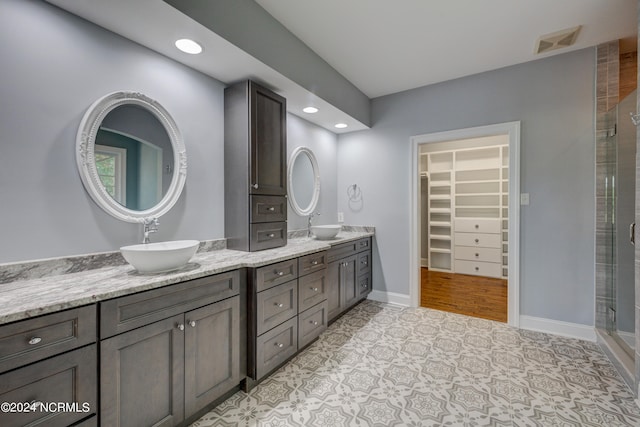 bathroom with an enclosed shower, hardwood / wood-style flooring, and vanity