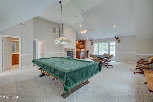 game room featuring light colored carpet, a stone fireplace, billiards, and ceiling fan