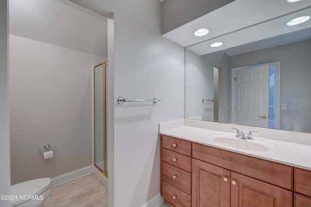 bathroom featuring walk in shower, vanity, and toilet