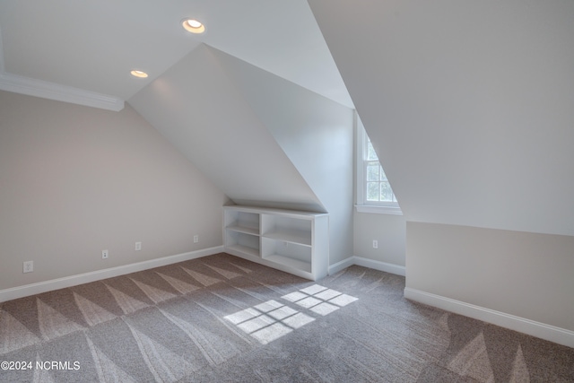 bonus room featuring vaulted ceiling and carpet floors