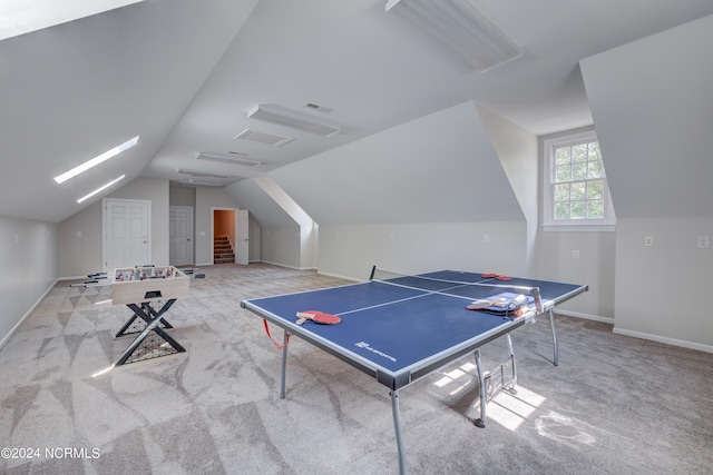 rec room featuring lofted ceiling and light carpet