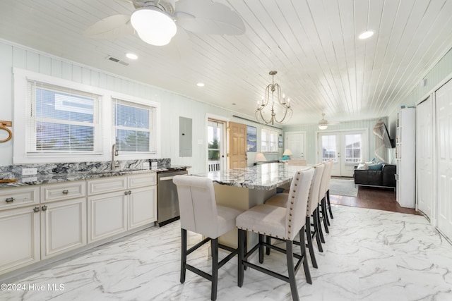 dining room featuring ceiling fan with notable chandelier, wooden ceiling, and plenty of natural light