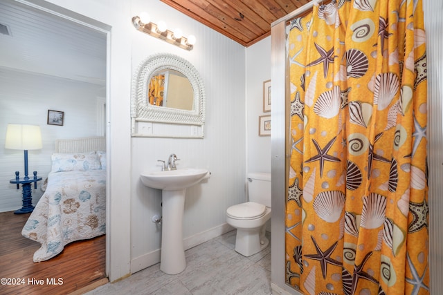 bathroom featuring toilet, sink, wooden ceiling, and walk in shower