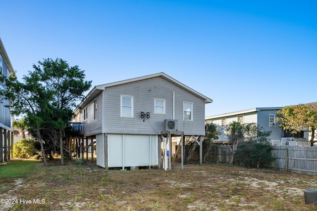 3016 W Beach Dr, Oak Island, NC 28465 - rear view of property with fence and ac unit