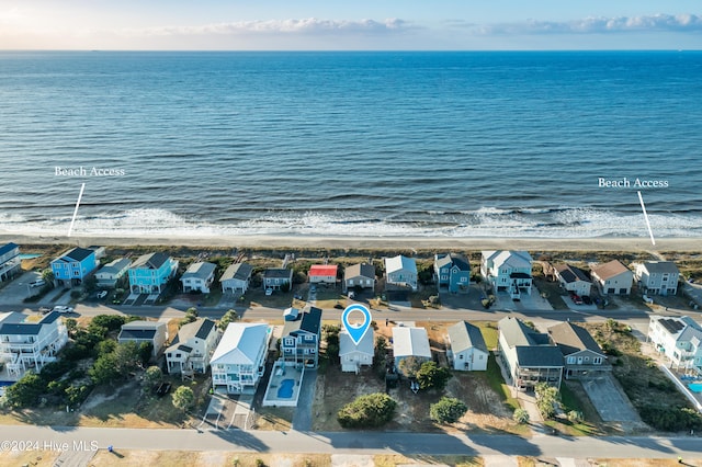 birds eye view of property featuring a beach view and a water view