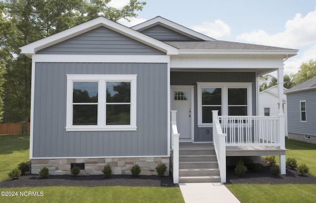 view of front of house with a porch and a front lawn