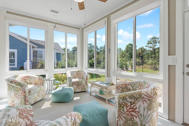 sunroom / solarium featuring ceiling fan