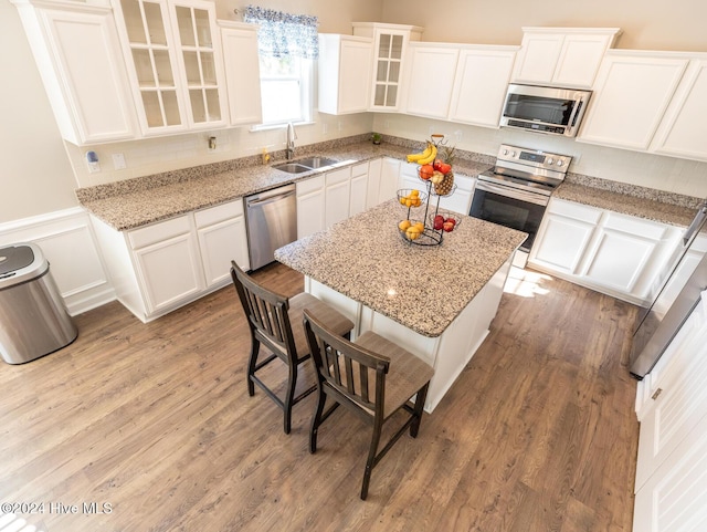 kitchen featuring light hardwood / wood-style floors, sink, white cabinetry, and stainless steel appliances