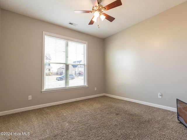 carpeted empty room featuring ceiling fan