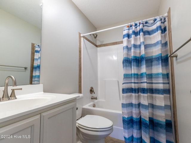 full bathroom featuring a textured ceiling, vanity, toilet, and shower / bath combo with shower curtain