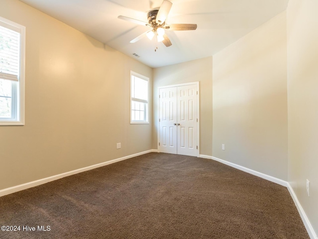 spare room featuring carpet and ceiling fan