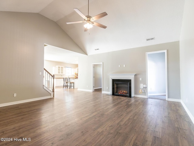 unfurnished living room featuring dark hardwood / wood-style flooring, high vaulted ceiling, and ceiling fan