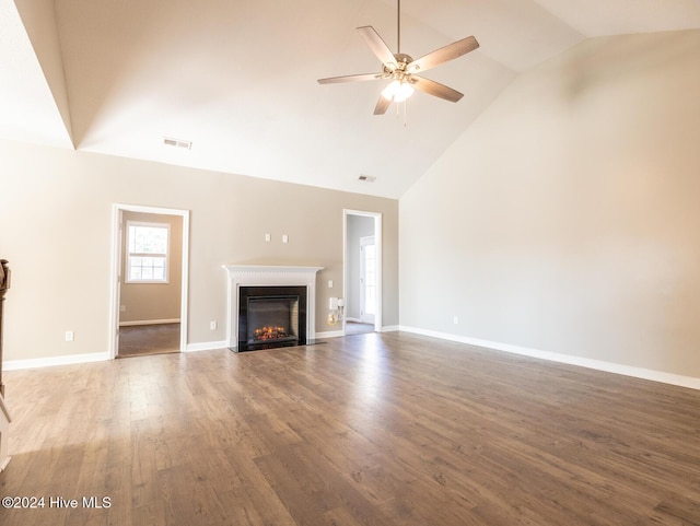 unfurnished living room featuring hardwood / wood-style floors, ceiling fan, and lofted ceiling