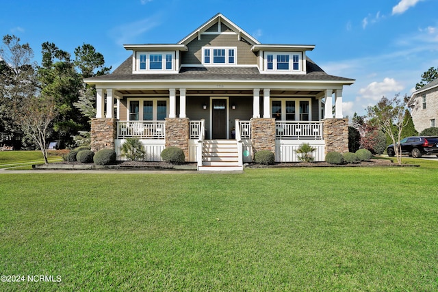 craftsman house featuring a front lawn and a porch