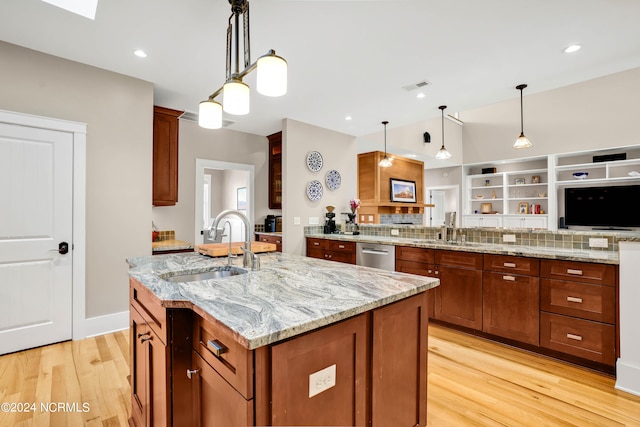 kitchen with dishwasher, light wood-type flooring, hanging light fixtures, and sink