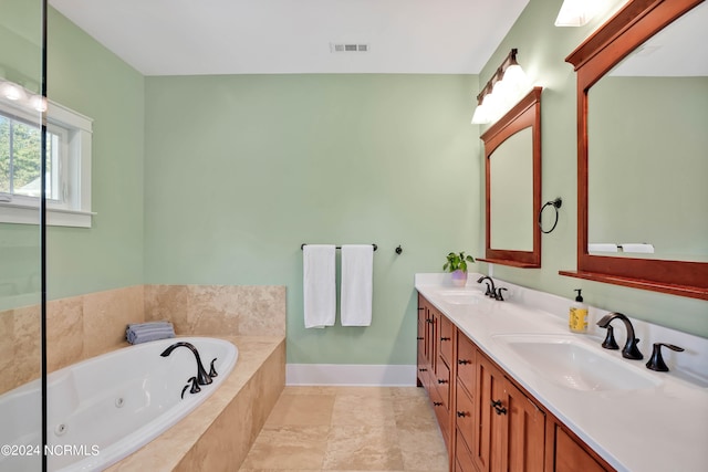 bathroom with vanity, a relaxing tiled tub, and tile patterned floors