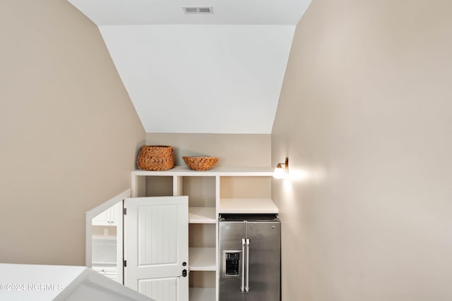 interior space featuring stainless steel fridge with ice dispenser