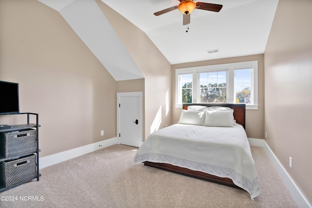 carpeted bedroom with vaulted ceiling and ceiling fan