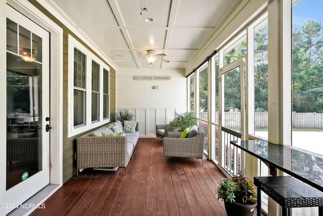 sunroom with a wealth of natural light, ceiling fan, and coffered ceiling