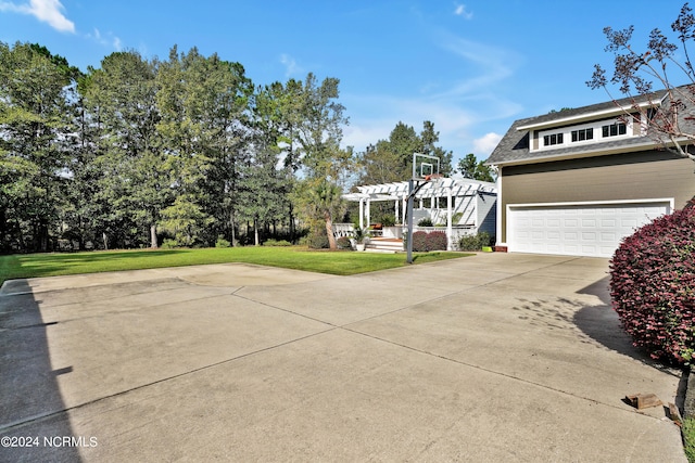 view of front of home with a pergola, a garage, and a front yard