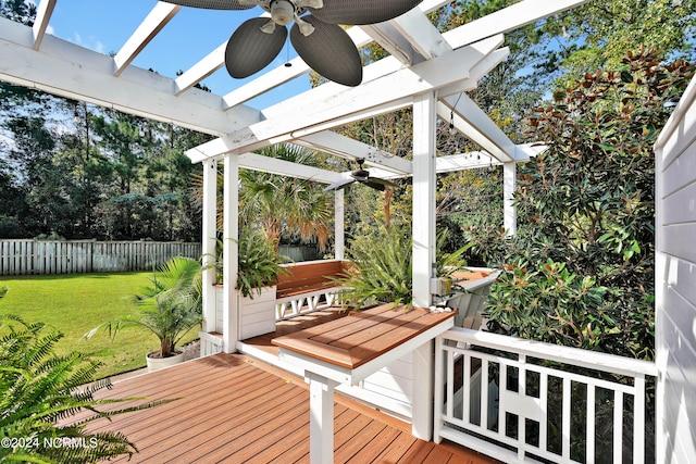 wooden deck featuring a lawn, a pergola, and ceiling fan