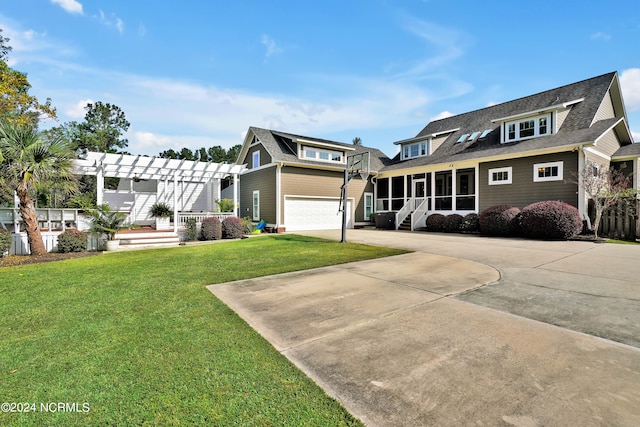 view of front of property with a garage, a front lawn, a pergola, and a sunroom