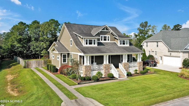 craftsman house with a garage, a front lawn, and a porch