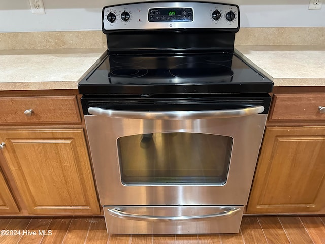 kitchen featuring light wood-type flooring and stainless steel range with electric cooktop