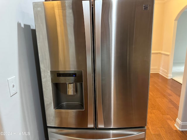 room details with stainless steel fridge with ice dispenser and light wood-type flooring