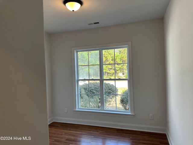 unfurnished room featuring dark wood-type flooring