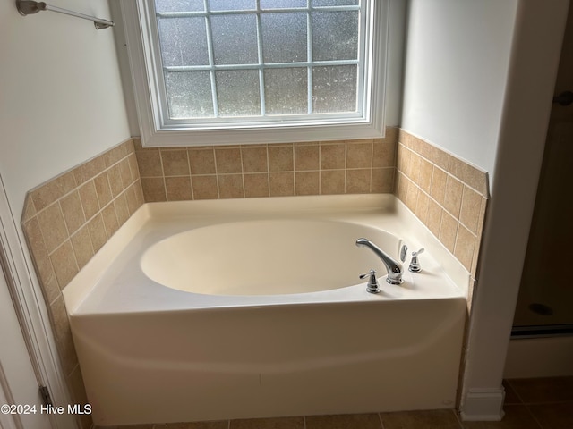 bathroom featuring plus walk in shower and tile patterned flooring