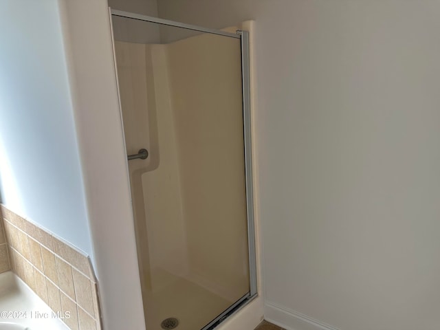 bathroom featuring a shower with door