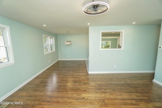 unfurnished room featuring dark hardwood / wood-style flooring and ceiling fan