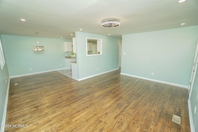 spare room featuring dark wood-type flooring