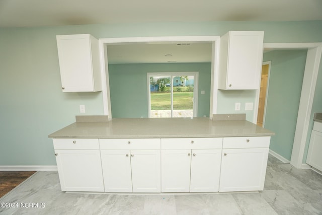 kitchen featuring light hardwood / wood-style floors and white cabinetry