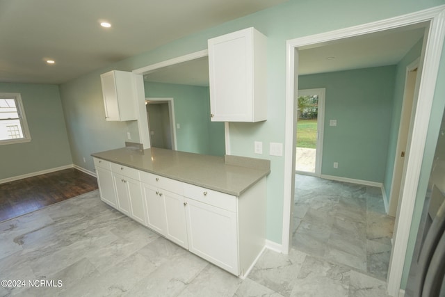 kitchen with light hardwood / wood-style floors and white cabinetry