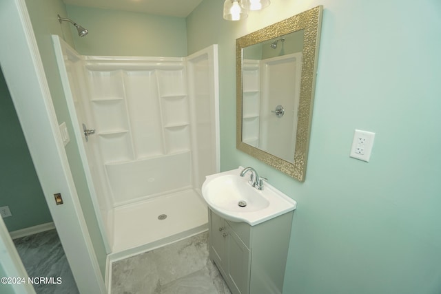 bathroom with walk in shower and vanity