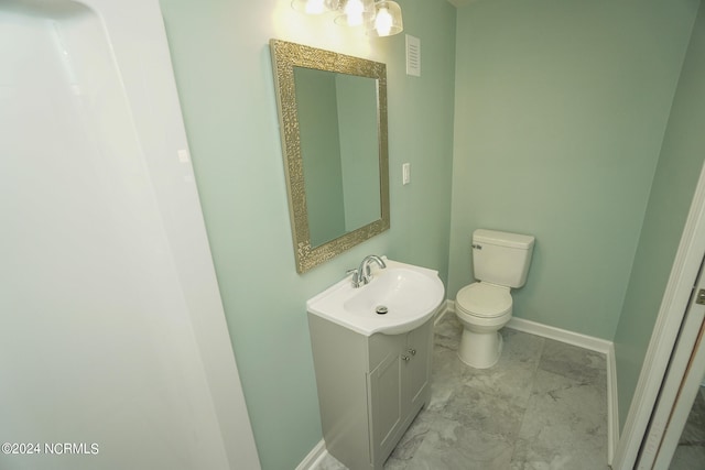 bathroom featuring vanity and toilet