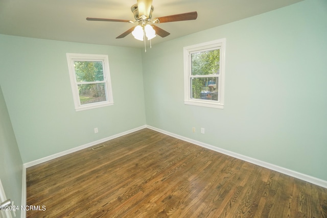 unfurnished room with ceiling fan, dark hardwood / wood-style floors, and plenty of natural light