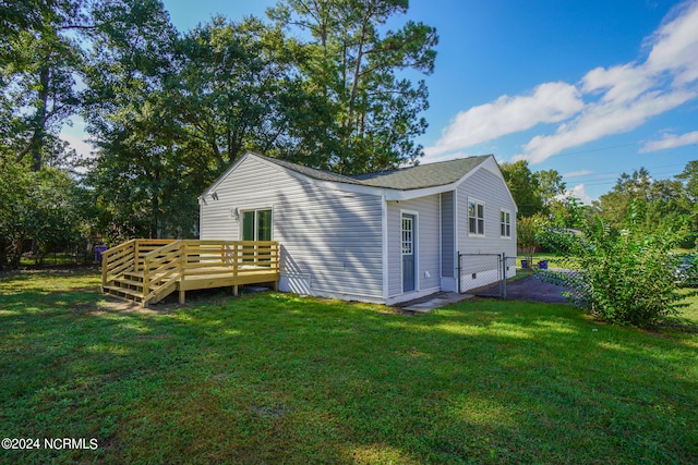 exterior space featuring a lawn and a deck