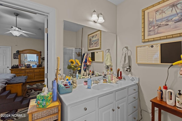 bathroom featuring vanity, ceiling fan, and a shower with shower door